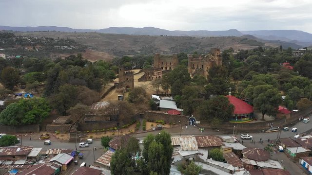 Establishing drone shot of historic Fasil Ghebbi fortress set on strategic hilltop in Gondar, tourism and cultural heritage Ethiopia