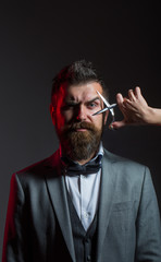 Barber scissors. Mens haircut. Bearded man, long beard, brutal, caucasian hipster with moustache, haircut. Handsome bearded. Barbershop. Sexy men, macho. Long beard. Vintage barbershop, shaving.