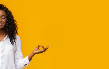 Half portrait of meditating afro girl with closed eyes