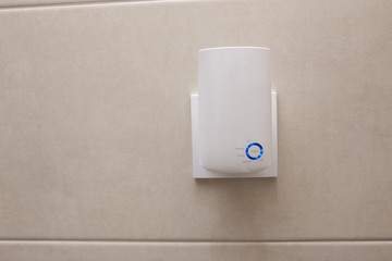 Wifi home repeater plugged in closeup.