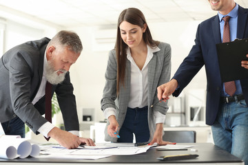 Team of architects discussing project in office