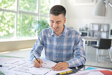 Handsome male architect working in office