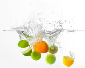 Fototapeta na wymiar Falling of different fruits into water on white background