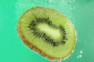 Ripe kiwi slice in water, closeup
