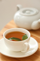 Cup of hot tea on table
