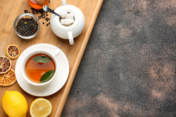 Obraz na płótnie Canvas Composition with hot tea on grunge background