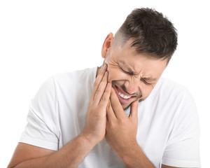 Man suffering from toothache against white background
