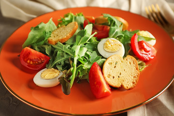 Tasty salad with arugula and eggs on plate, closeup