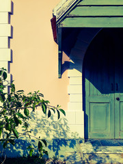 The vintage style concept of the background of the building wall with doors and trees is an element, the architecture of the building that blends perfectly with the composition of the picture
