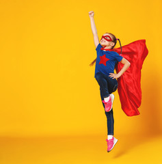 concept of child superhero costume on yellow background. © JenkoAtaman