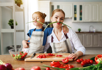 happy family mother with child girl preparing vegetable salad