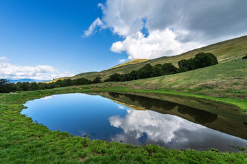 Small lake with reflections with sky and clouds, Monte Baldo, Italian Alps near Verona and lake Garda, Veneto, Italy, south Europe © Alberto Masnovo