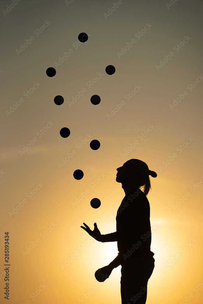 Canvas Prints Silhouette of a man Juggling with Balls at Sunset