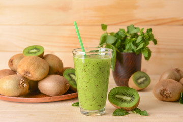 Glass of tasty kiwi smoothie on table