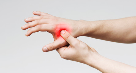 Man holding hand to spot of palm-ache, panorama