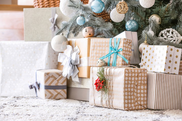 Many beautiful gift boxes under Christmas tree