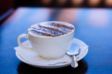 A cup of cappuccino espresso-based coffee drink, close up.