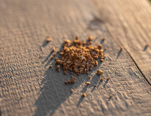 freeze-dried coffee sprinkled on a wooden background