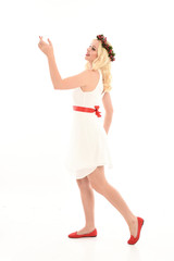 full length portrait of blonde girl wearing a white dress and flower crown.  Standing pose, isolated against a  white studio background.