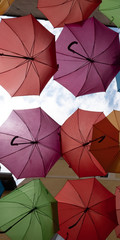 Street decorated with bright colorful artistic umbrellas along the streets