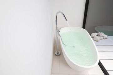white bathtub with water in new modern hotel