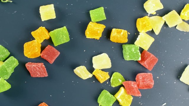 Nice sweet jelly candy with shugar on dark surface. Close up of colour food.