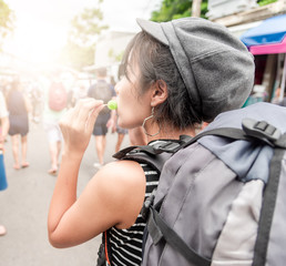 Young Asian cute woman traveler tourist shopping walking on the famous local street market with backpack , food local , vacation,hipster tourism concept