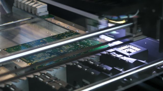 Close-up of printed circuit board which is created by special automatic machine in a workshop. Media. Electronics and technology concepts.