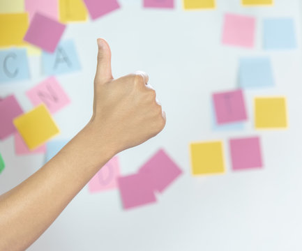 Thumbs up by right hand with frame of blank sticky note , which is used for education, business, communication  is stuck around the white background with copy space .Remember idea for team concept