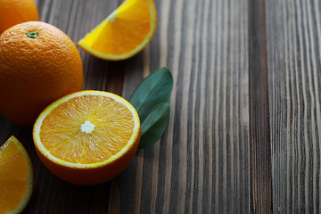 Orange citrus fruit on a stone table. Orange background.