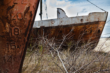 Old rusty river ship on the shore