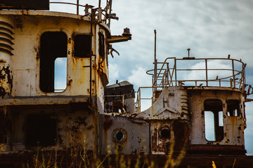 Fototapeta na wymiar Old rusty river ship on the shore
