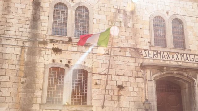 barrack with italian flag, old military structure (first use: hospital, then barracks and finally prison) in Peschiera del garda - Italy