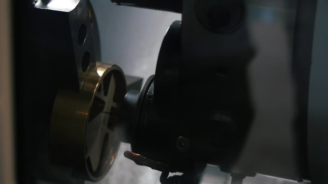 Close-up view of metal engraving automatic machine during operation on the factory. Media. Industrial and construction concepts