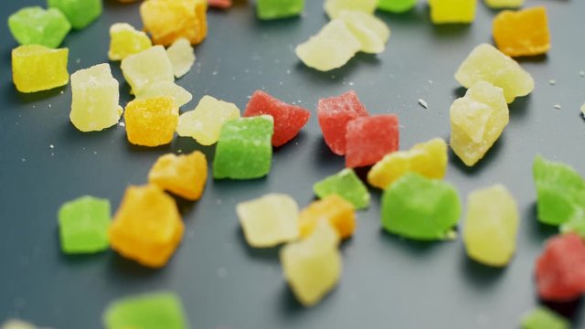 Nice sweet jelly candy with shugar on dark surface. Close up of colour food.