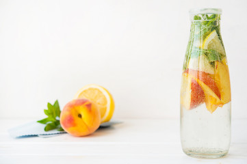 Homemade detox drink of lemon and peach in a bottle. Horizontal photo with copy space.