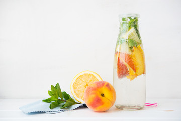 Homemade detox drink of lemon and peach in a bottle. Horizontal photo with copy space.