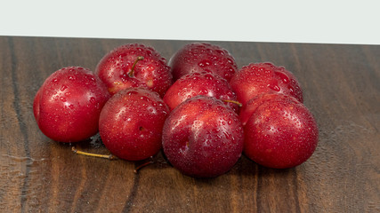 sprinkle water on many red plums isolate 