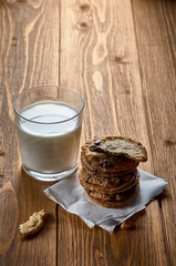 a stack of cookies with chocolate and a glass of milk