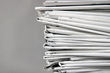 pile of newspapers, tracking shot of a stack of journals