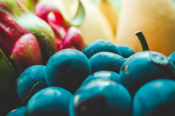 Photograph of ripe tropical fruit and berries close-up