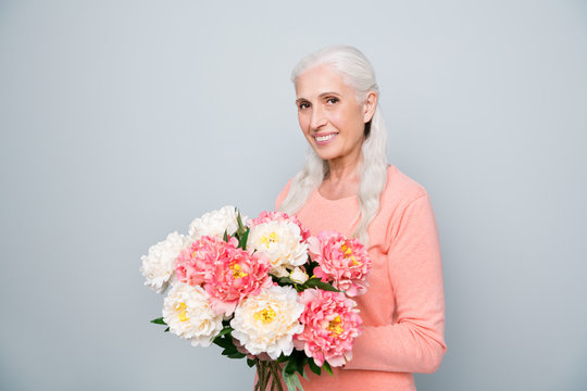 Photo portrait of nice positive glad sweet lovely dream dreamy wife holding big bouquet in hands from her husband isolated grey background