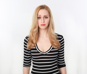 3/4 portrait of pretty blonde lady wearing stripes shirt, isolated against a white studio background.