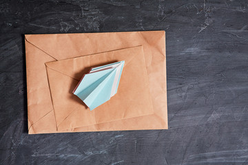 Email or sms marketing and sending e-mail, connection message concept: A stack of paper airplanes and envelopes.