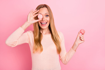 Close up photo of beautiful lady hide eye with little french macaron excited carefree wear pastel pullover isolated pink background