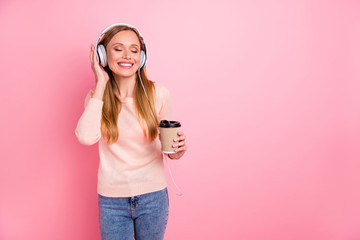 Photo of beautiful lady eyes closed listen favorite playlist earflaps takeout paper coffee wear...