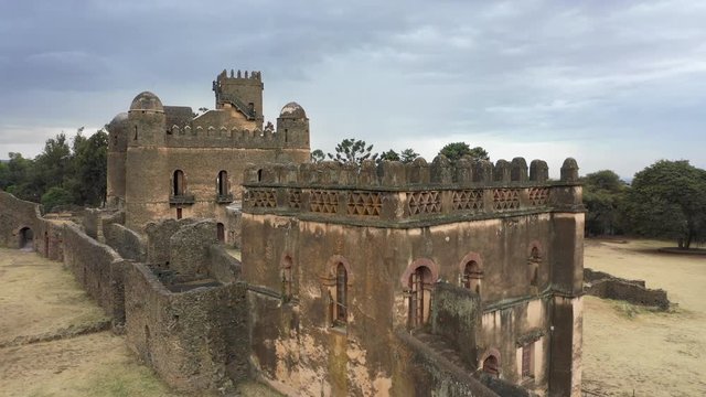 Ascending drone flight reveals historic palace (Fasil Ghebbi fortress) in Gondar, tourism and cultural heritage in Ethiopia