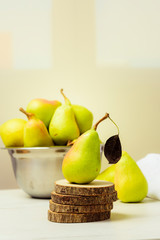 fresh and green pears on a wooden table