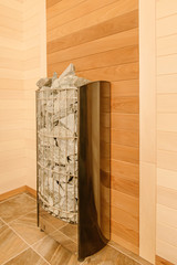 Sauna interior with electric stove and linden-clad walls