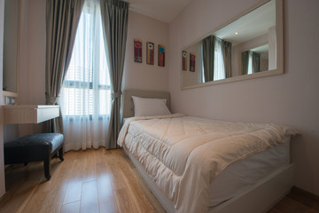 Interior of modern bedroom with cozy double bed